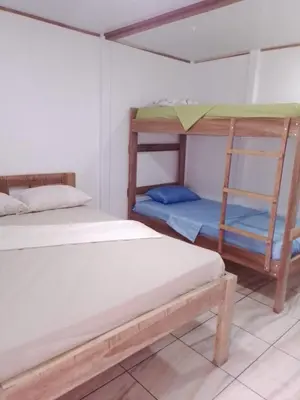 a room with two bunk beds and a ladder at Amaya's Hostel in Jaloba