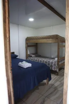 a bedroom with two bunk beds with blue sheets at Amaya's Hostel in Jaloba