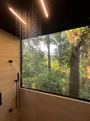 a shower with a large window in a bathroom at Sweet Jungle in Quesada