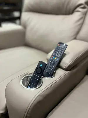 two remote controls sitting on top of a couch at Sweet Jungle in Quesada
