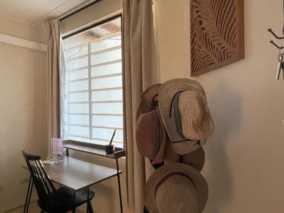 a room with a table and hats on the wall at Casa Buda 2 Liberia cerca del aeropuerto in Liberia
