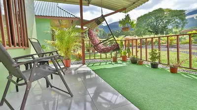 a porch with a hammock and a swing at Chongos Place in Fortuna