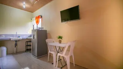 a dining room with a table and a tv on the wall at Chongos Place in Fortuna