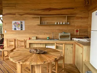 a wooden kitchen with a wooden table and a counter at Bungalows Baobab in San Isidro