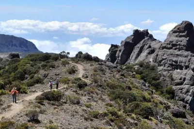 people walking on a trail in the mountains at Bungalows Baobab in San Isidro