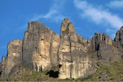a large rocky mountain with a blue sky in the background at Bungalows Baobab in San Isidro