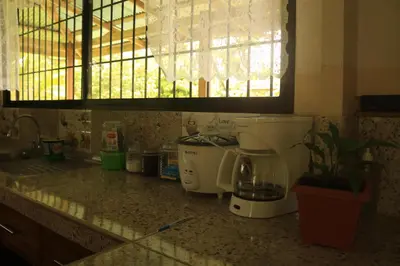 a kitchen counter with a coffee maker and a window at Green House in Samen