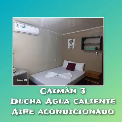 a room with a bed in a hotel room at Apartamentos Caimán 3 in Tortuguero
