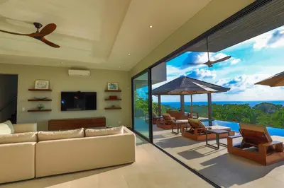 a living room with a view of the ocean at Casa Solaz - by Pura Villas in Dominical