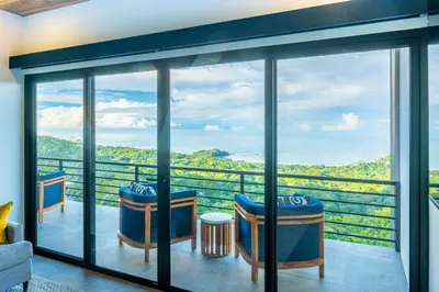 a view from the balcony of a house with a view at Casa Amigos - By Pura Villas in Dominical
