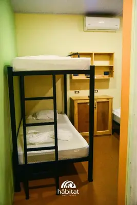 a bunk bed in a small room with a bunk bed at Habitat Surf Glamp in Santa Teresa Beach