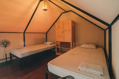 a room with two beds in a tent at Habitat Surf Glamp in Santa Teresa Beach