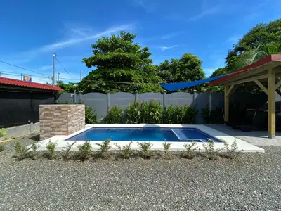 a swimming pool in the backyard of a house at Cabaña ValFio Bahía Ballena in Uvita