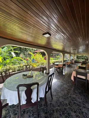 a dining room with a table and chairs at Brillasol Airport Hotel in Alajuela City