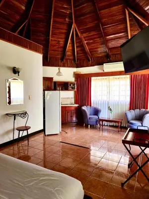 a room with a kitchen and a living room at Hotel Villa Acacia in Playa Hermosa
