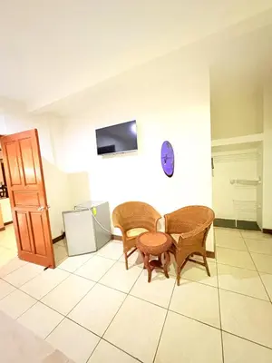 a dining room with two chairs and a table at Hotel Villa Acacia in Playa Hermosa