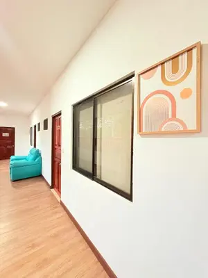a room with white walls and a blue couch at Hotel Villa Acacia in Playa Hermosa