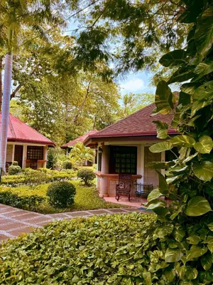 a house with a patio in front of it at Hotel Villa Acacia in Playa Hermosa