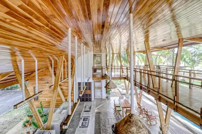 a wooden house with a large ceiling at Mangue House in Playa San Miguel