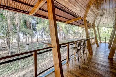 a room with a table and chairs and trees at Mangue House in Playa San Miguel
