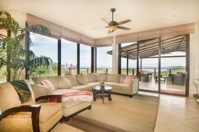 a living room with a couch and a ceiling fan at Luxury Home with Views and Infinity Pool Near Beach! in Puerto Viejo
