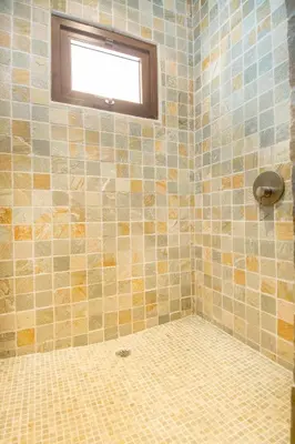 a bathroom with a tiled shower with a window at Luxury Home with Views and Infinity Pool Near Beach! in Puerto Viejo