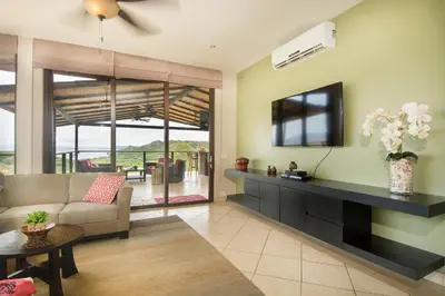 a living room with a couch and a tv at Luxury Home with Views and Infinity Pool Near Beach! in Puerto Viejo