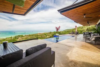 an indoor patio with a view of the ocean at Casa Anna Santa Teresa in Santa Teresa Beach