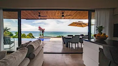 a living room with a view of the ocean at Casa Anna Santa Teresa in Santa Teresa Beach