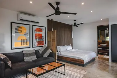 a living room with a bed and a couch at Le Suite in Santa Teresa Beach