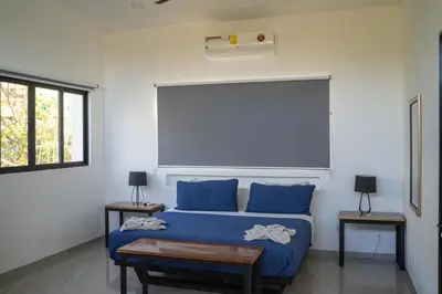 a bedroom with a blue bed and two tables at Vista Loma Estate in San Isidro