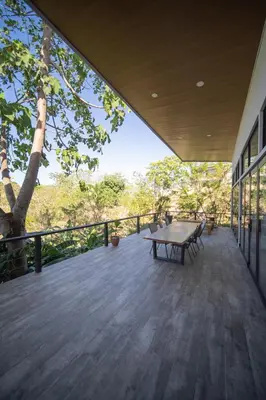 a wooden deck with a picnic table and a tree at Vista Loma Estate in San Isidro