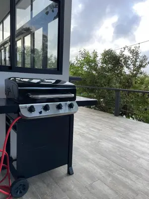 a grill on a deck with a view of a house at Vista Loma Estate in San Isidro