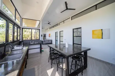 an open kitchen with a large island with bar stools at Vista Loma Estate in San Isidro