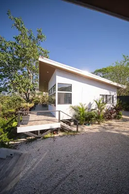 a white house with a pathway in front of it at Vista Loma Estate in San Isidro