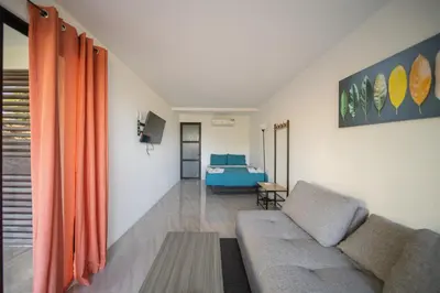 a living room with a couch and a bed at Vista Loma Estate in San Isidro