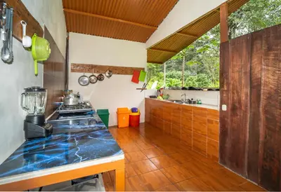 a kitchen with a stove and a counter top at Playa Ganadito Ecolodge in Drake