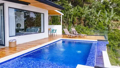 a swimming pool in the backyard of a house at Casa Nina Santa Teresa in Santa Teresa Beach