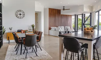 a kitchen and dining room with a table and chairs at Casa Nina Santa Teresa in Santa Teresa Beach