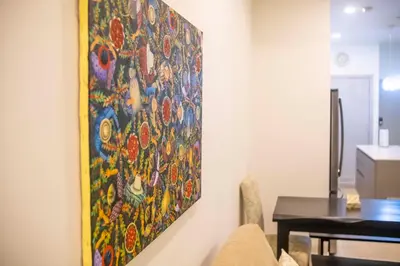 a painting hanging on a wall in a room at SUNSET OCEAN VIEW CONDO in Jacó