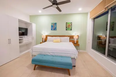 a bedroom with a bed and a ceiling fan at SUNSET OCEAN VIEW CONDO in Jacó