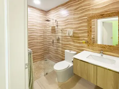 a bathroom with a toilet and a sink and a shower at SUNSET OCEAN VIEW CONDO in Jacó
