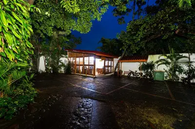 a house with a lit up garage at night at Costa Verde Inn in San José