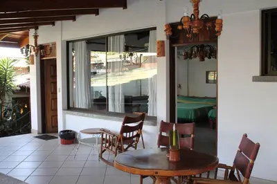 a patio with a table and chairs and a bedroom at Costa Verde Inn in San José