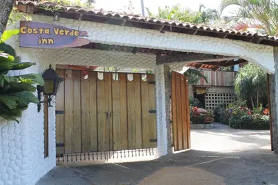 an entrance to a house with a wooden gate at Costa Verde Inn in San José