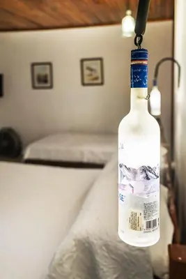 a bottle of wine hanging from a ceiling at Costa Verde Inn in San José