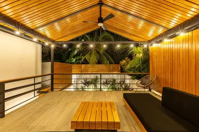 a balcony with a wooden bench and a projection screen at Ventura Santa Teresa in Santa Teresa Beach
