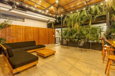 a living room with a couch and some plants at Ventura Santa Teresa in Santa Teresa Beach