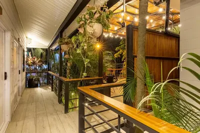 an indoor patio with plants and a table at Ventura Santa Teresa in Santa Teresa Beach