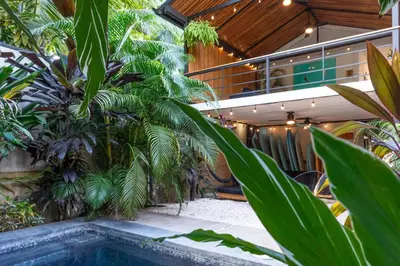 an indoor garden with a swimming pool and plants at Ventura Santa Teresa in Santa Teresa Beach